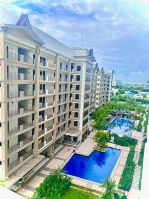 an aerial view of a building with a swimming pool at Calathea Luxe Atrium Suite in Manila