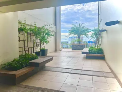 a balcony with benches and a view of the ocean at Calathea Luxe Atrium Suite in Manila