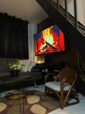 a living room with a tv on a wall at Binangonan Jarmelas Tiny Home with Free Breakfast in Binangonan