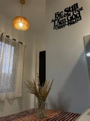 a vase sitting on a table in a room with a window at Binangonan Jarmelas Tiny Home with Free Breakfast in Binangonan