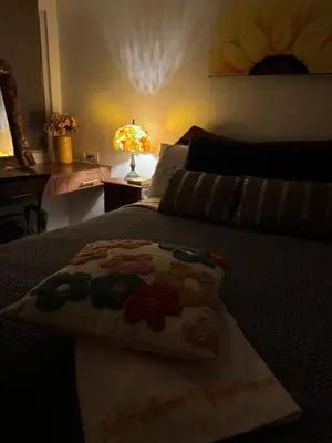 a bedroom with a bed with a pillow on it at Julie Annes Guesthouse in the Heart of the City in Manila