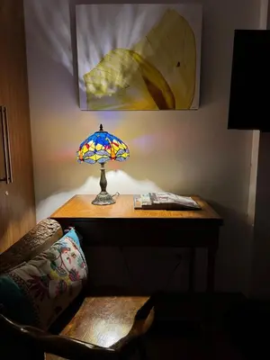 a table with a lamp on top of a desk at Julie Annes Guesthouse in the Heart of the City in Manila