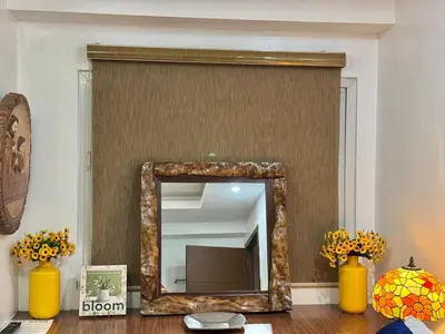 a mirror on a wall in a room with yellow vases at Julie Annes Guesthouse in the Heart of the City in Manila