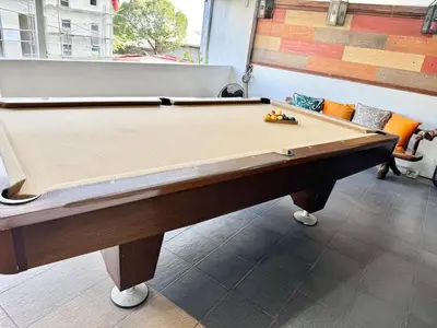a pool table sitting inside of a room with at Julie Annes Guesthouse in the Heart of the City in Manila
