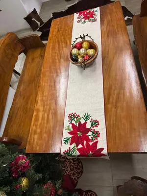 a wooden table with a bowl of fruit on it at Julie Annes Guesthouse in the Heart of the City in Manila