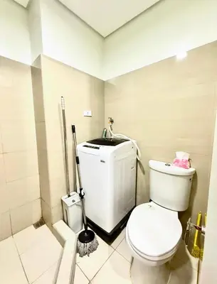 a bathroom with a toilet and a mop at shore 2 residences tower 2 16fl in Manila