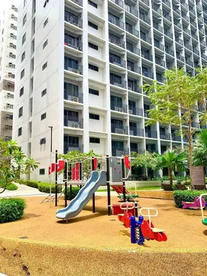 a playground in front of a large apartment building at shore 2 residences tower 2 16fl in Manila