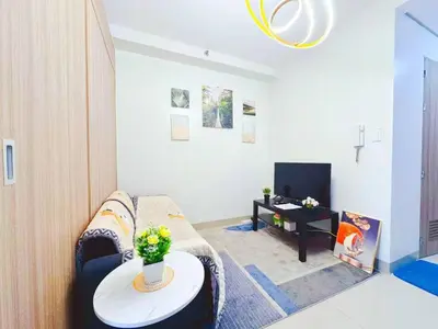 a living room with a couch and a table at shore 2 residences tower 2 16fl in Manila