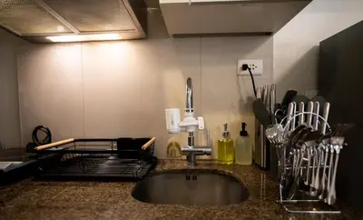 a kitchen with a sink and a counter top at Elegant unit, fast wifi, near Makati Medical Centr in Manila