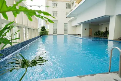 a large swimming pool in the middle of a building at Elegant unit, fast wifi, near Makati Medical Centr in Manila