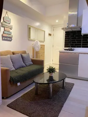 a living room with a couch and a coffee table at Azure Staycation by Zette in Manila