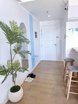 a plant in a white room with a hallway at Luxury Coastal Suite, Grand Canal view in Manila