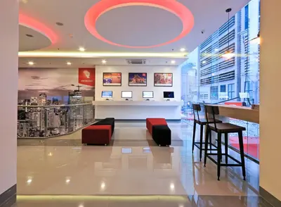 a lobby of a building with a bar and chairs at Red Planet Makati Amorsolo in Manila