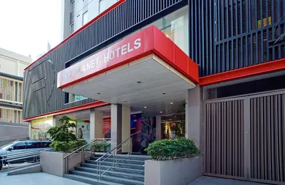 a store front of a building with a sign on it at Red Planet Makati Amorsolo in Manila