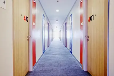 a hallway of an office with a row of doors at Red Planet Makati Amorsolo in Manila