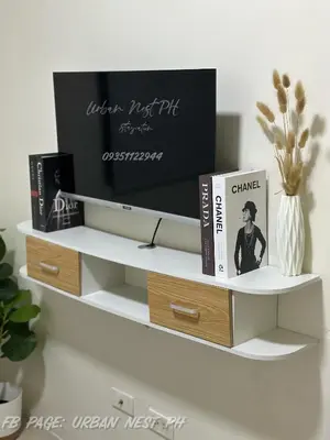 a white shelf with books and a tv on it at Jam Reid Condotel Mandaluyong in Manila