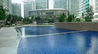 a large pool of water in a city with buildings at Upscale 1Bedroom Condo Unit Near Manila Airport in Manila