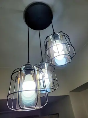 a chandelier with three lights hanging from a ceiling at An-Dy's Point, Field Residences in Manila