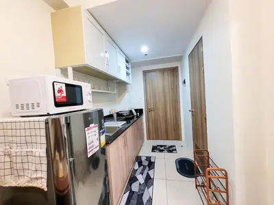 a small kitchen with a refrigerator and a microwave at An-Dy's Point, Field Residences in Manila