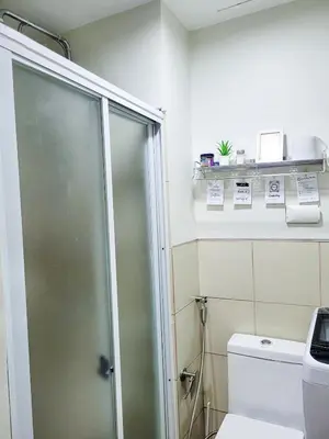 a bathroom with a shower and a toilet at An-Dy's Point, Field Residences in Manila