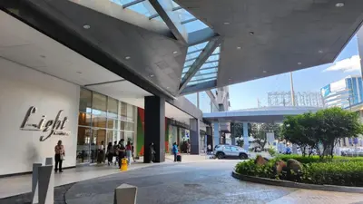 a shopping mall with people walking in front of it at SMDC Light Residences Condominium in Manila