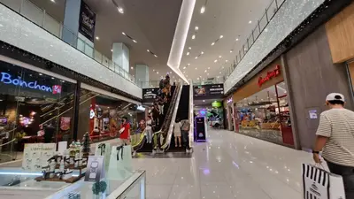a shopping mall with people walking through it at SMDC Light Residences Condominium in Manila