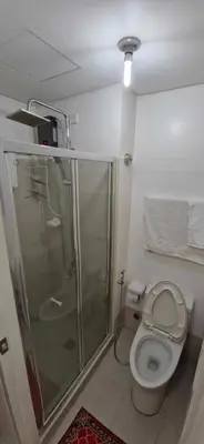 a bathroom with a shower and a toilet at SMDC Light Residences Condominium in Manila