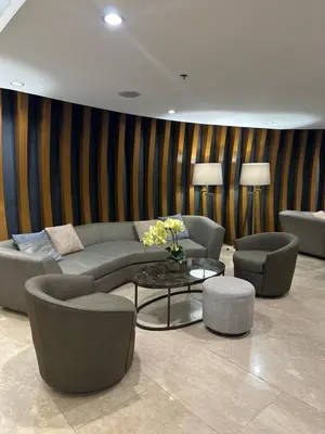 a living room with a couch and chairs and a table at Mall of Asia Vermilion Grand Suite in Manila