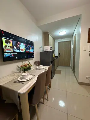 a kitchen and dining room with a table and chairs at Mall of Asia Vermilion Grand Suite in Manila