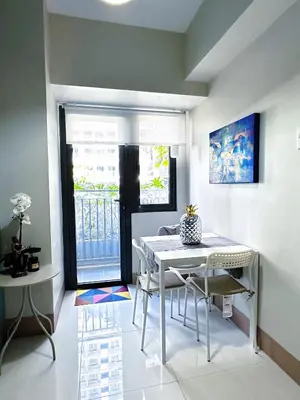 a dining room with a table and chairs at The Ilongga Haven 3 Staycation at Mall of Asia in Manila