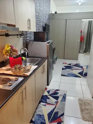 a kitchen with a sink and a refrigerator at La Luz 0835 Smdc Breeze in Manila