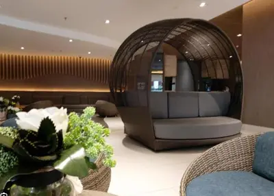 a lobby with a couch and a chair in a room at Unistay SHORE Residence amazing pool view in Manila