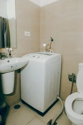 a bathroom with a sink and a toilet at MOA city view in Manila