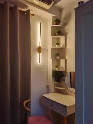 a bathroom with a toilet and a sink and shelves at Mk Luxury Staycation in Manila
