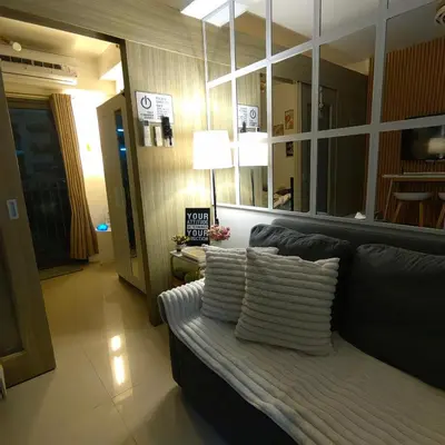 a living room with a couch and a mirror at Mk Luxury Staycation in Manila