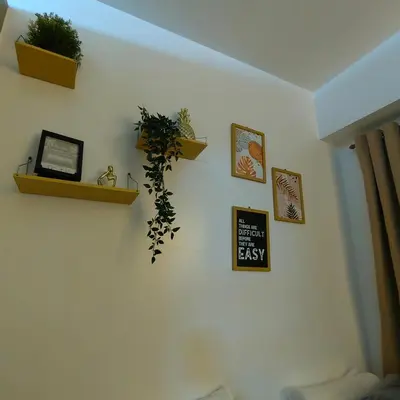 a living room with plants on a white wall at Mk Luxury Staycation in Manila