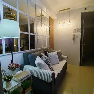 a living room with a couch and a lamp at Mk Luxury Staycation in Manila