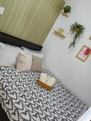 a bedroom with a bed with a black and white comforter at Mk Luxury Staycation in Manila