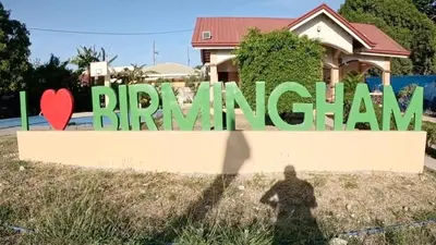 a man standing in front of a sign that reads bangatown at Eco's Place GenTri - Family Bungalow in General Trias