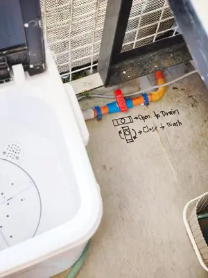 a white toilet sitting next to a clock on the floor at Eco's Place GenTri - Family Bungalow in General Trias