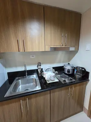a kitchen with a sink and a counter top at Shore 3 Residences tower 3 in Manila
