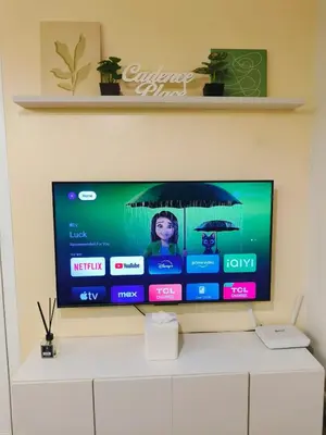 a flat screen tv sitting on top of a white cabinet at 2BR Pasig Condo for Family or Group with Parking in Manila