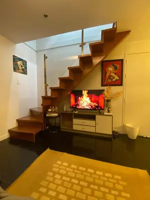 a living room with a fire in the fireplace at ECN Suite and Staycation in Manila