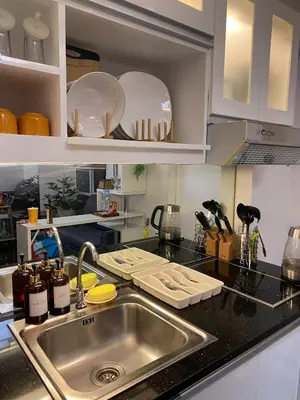 a kitchen with a sink and a counter top at ECN Suite and Staycation in Manila