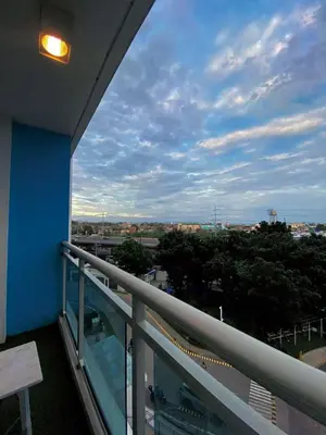 a balcony with a view of a city at Yumi Azure Staycation in Manila