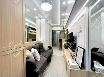 a living room with a couch and a tv at A2 Condotel Suites in Manila