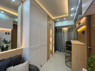 a small room with a kitchen and a bar in aurynell house at A2 Condotel Suites in Manila
