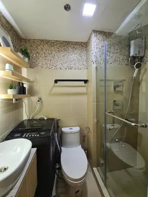 a bathroom with a toilet and a sink and a shower at A2 Condotel Suites in Manila