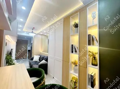 a room with a living room with a couch and a room at A2 Condotel Suites in Manila