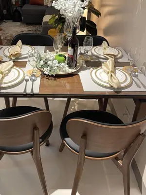 a dining room table with plates and a bottle of wine at Funky HQ - 1BR Eastwood Global Plaza in Manila